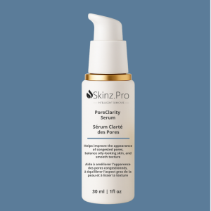 bottle of Skinz.Pro PoreClarity Serum with gold pump on blue background – balancing serum for oily and congested skin